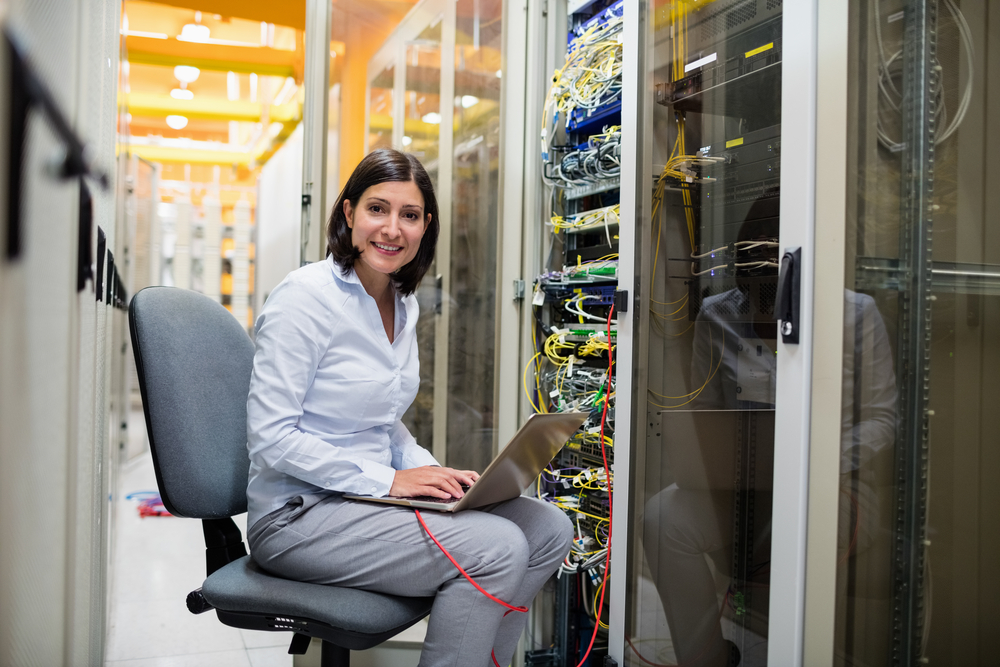 echnician-working-on-laptop-in-server-room