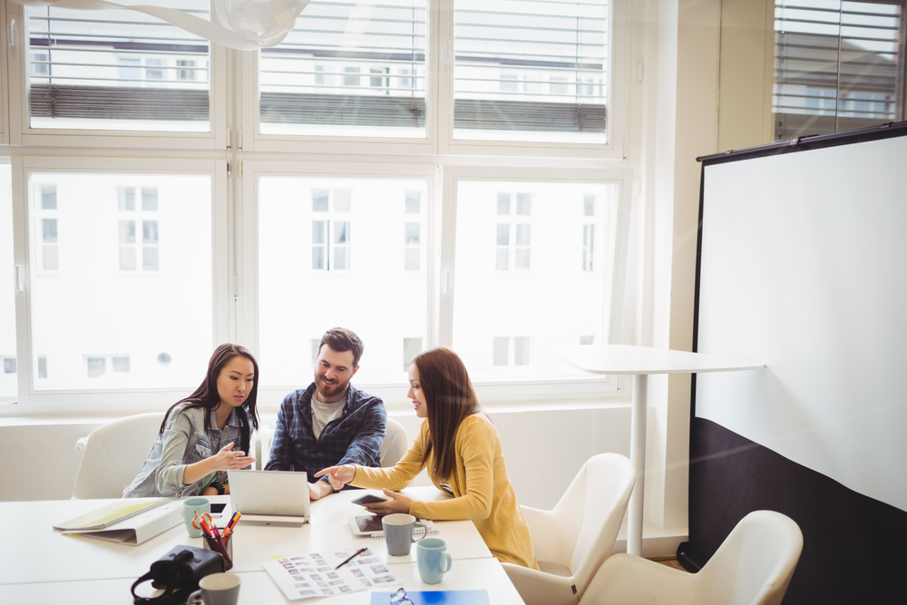 work team using laptop in meeting room at office